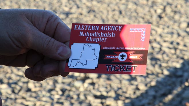 A member of the Nahodishgish Chapter of the Navajo Nation presents a ticket handed out by chapter houses for members to receive free allotments of coal for home heating at Navajo Mine in Fruitland on Feb. 6, 2020.