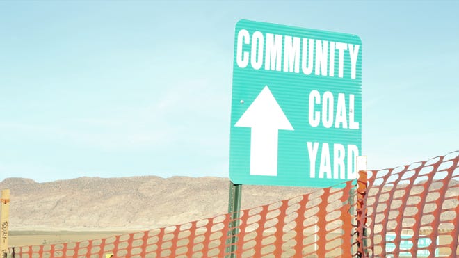 A sign pointing community members towards the community coal yard at Navajo Mine in Fruitland on Feb. 6, 2020.