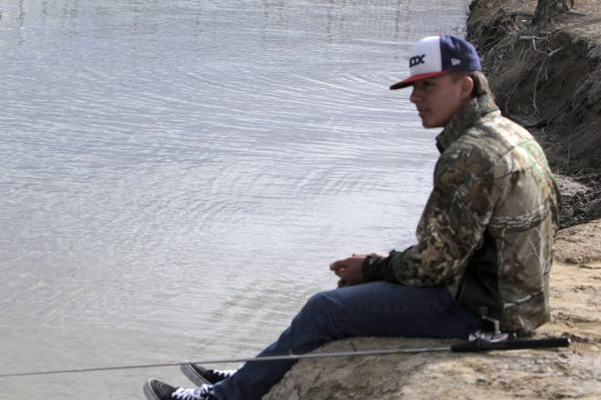Cameron Swarts waits for a fish to bite, Monday, Feb. 17, 2020, at Lake Farmington.