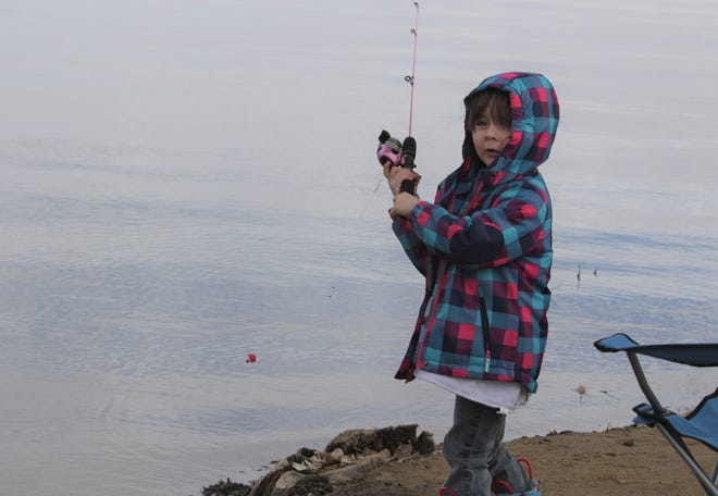 Piper Chivers, 4, fishes from shore, Monday, Feb. 17, 2020, at Lake Farmington.