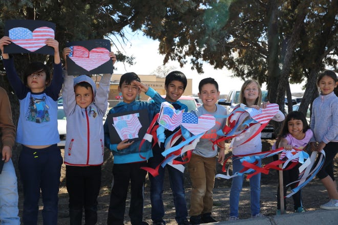Students at Fairacres Elementary School pay tribute to fallen Las Cruces soldier, SFC Antonio Rey Rodriguez, as his motorcade passes the school along Picacho Avenue on Tuesday, Feb. 18, 2020. Rodriguez is a former student at the elementary school.