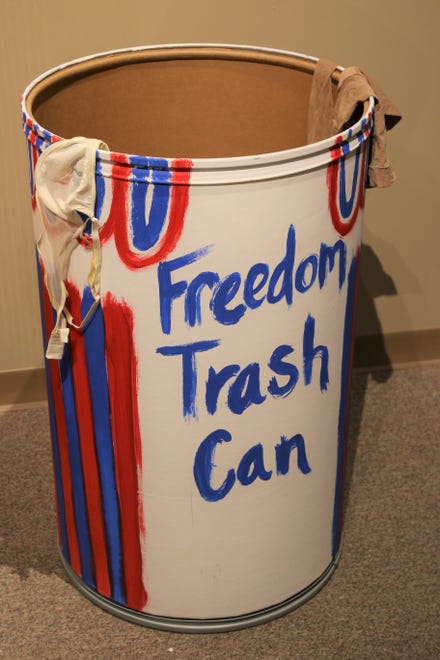 A Freedom Trash Can adorned with discarded bras and stockings is part of the "Inside Out" exhibition at the Farmington Museum at Gateway Park.