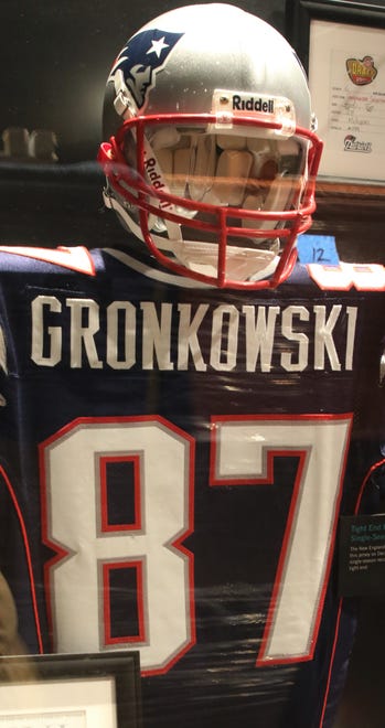 Tom Brady's helmet and Rob Gronkowski's jersey are part of a New England Patriots display in the "Gridiron Glory" exhibition.