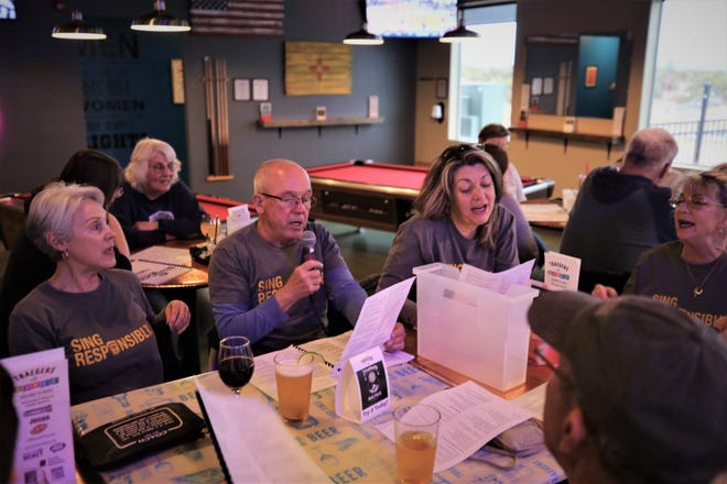Beer Choir enthusiasts raise their voices in unison during a March 11 session at Traegers bar in Farmington.