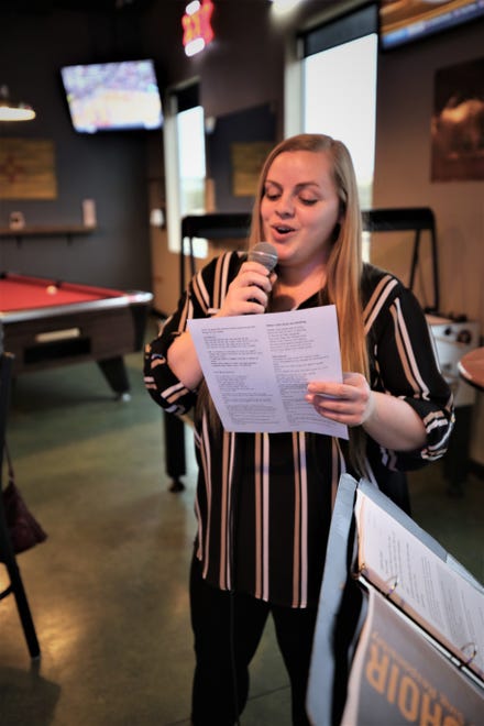 Brooke Tomlinson belts out "Danny Boy" during the March 11 Beer Choir gathering at Traegers bar in Farmington.