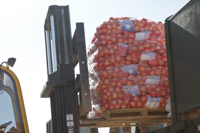 A pallet of onions is removed during a food delivery by members of the New Mexico Army National Guard and the New Mexico Air National Guard on April 15, 2020 in Sheep Springs.