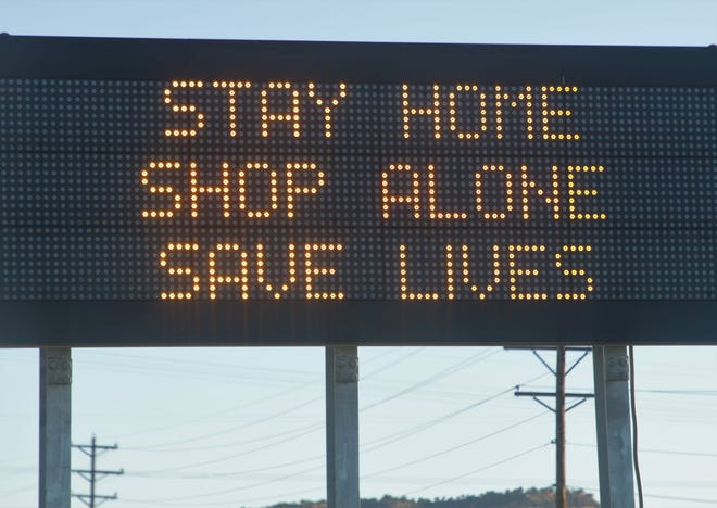 A New Mexico Department of Transportation electronic sign near Gallup displays the phrase state and tribal officials have been saying to the public as part of efforts to combat the coronavirus in communities.