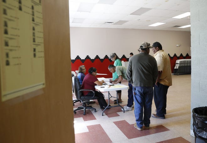 Voters form a line to receive ballots during the Navajo Nation primary election on Aug. 30, 2016 at the Tsé Daa K'aan Chapter house in Hogback.