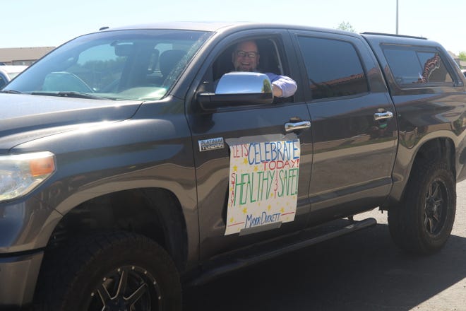 Mayor Nate Duckett smiles from behind the wheel of his truck as he takes part in the Parking Lot Love Parade at The Bridge at Farmington assisted living center on May 13, 2020.