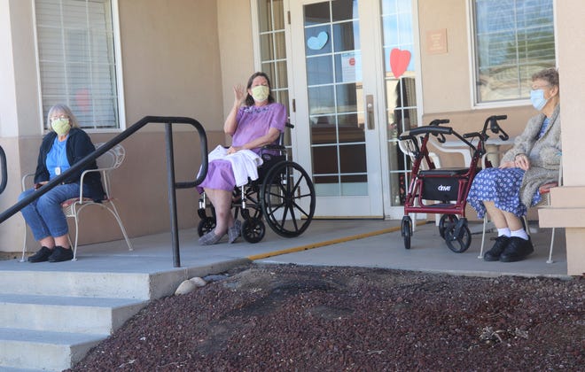 Residents of The Bridge at Farmington assisted living center wave to participants in the Parking Lot Love Parade on May 13, 2020.