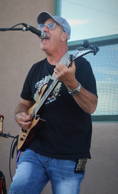 Jose Villareal leads his band through a song during the opener of the Sunset Curbside Concert Series on May 13, 2020, at Clancy's Irish Cantina in Farmington.