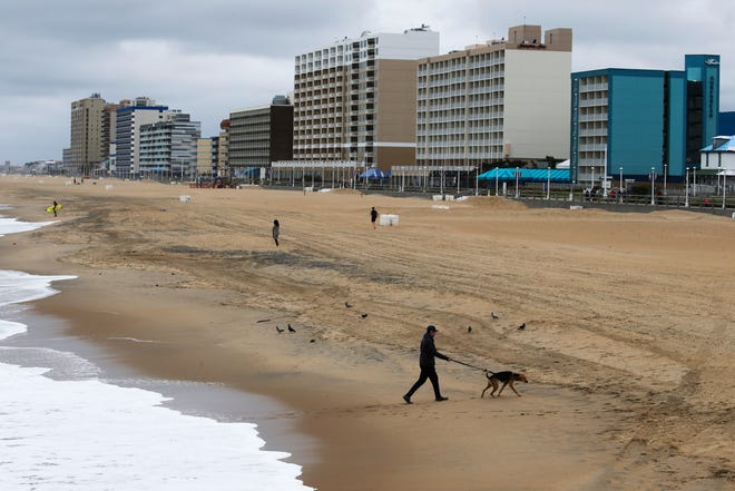 Restrictions on Virginia Beach in Virginia Beach, Va. continue, restricting beach access to exercise and fishing only. No swimming is allowed currently. Few are seen exercising on April 4, 2020.