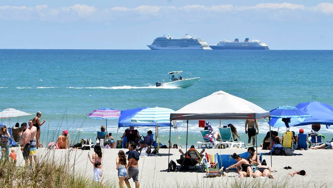 People enjoy the sun and sand at Lori Wilson Park in Cocoa Beach on May 2, 2020. Although spring break hotspot, restrictions continue at Cocoa Beach, allowing only groups of five or less.