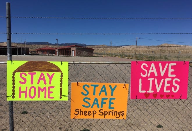 Community members in Sheep Springs are reminded about staying at home to combat the novel coronavirus. The signs are pictured on April 5 at the flea market in Sheep Springs.