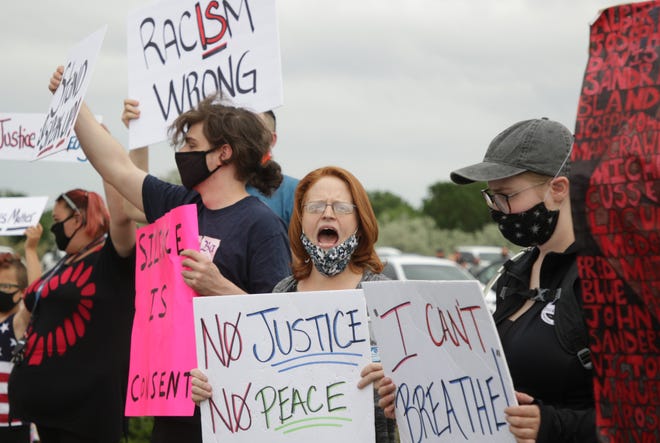 Jay Caston, center, leads demonstrators in chants during a peaceful protest for the Black Lives Matter movement in front of the Farmington Museum at Gateway Park on June 5 in Farmington.