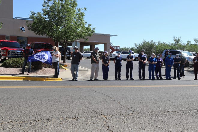 Emergency Medical Services staff wait for a procession, Sunday, June 14, 2020, in front of San Juan Regional Medical Center. The procession left Albuquerque that afternoon to bring the body of paramedic Glovis Foster back to Farmington.