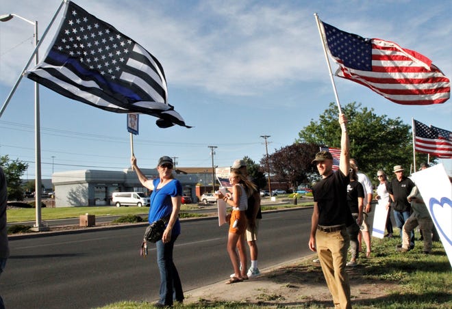 Demonstrators show support for law enforcement, Friday, June 19, 2020, in front of Animas Valley Mall on East Main Street in Farmington.