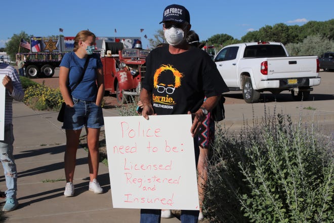Matt Dodson stands in front of the Farmington Museum at Gateway Park during a protest against police brutality on Friday, June 19, 2020, in Farmington.