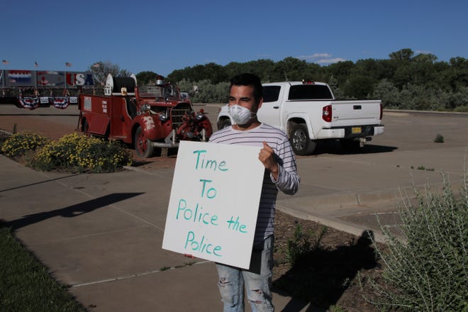 Damian Artalejo in front of the Farmington Museum at Gateway Park during a protest on Friday, June 19, 2020, in Farmington.