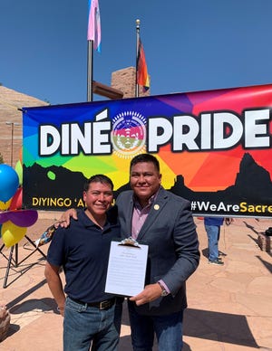 Diné Pride Finance Director Brennen Yonnie, left, and Executive Director Alray Nelson show the proclamation for Diné Pride Week after the signing ceremony on June 22 in Window Rock, Arizona. The couple have been advocating for marriage equality on the Navajo Nation since 2013.