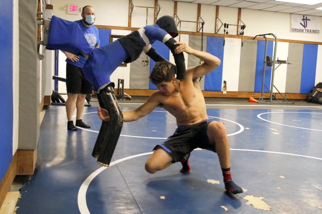 Carlsbad junior Jesse Rodriguez works with "Adam" while head coach Joe Bach watches his technique on June 25, 2020.