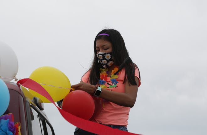 Adoncia James decorates her family's truck before the Diné Pride Cruise on June 26 in Window Rock, Arizona.