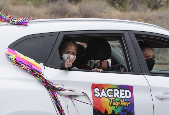 Diné Pride Cruise participants drive past Navajo Nation government buildings on June 26 in Window Rock, Arizona.