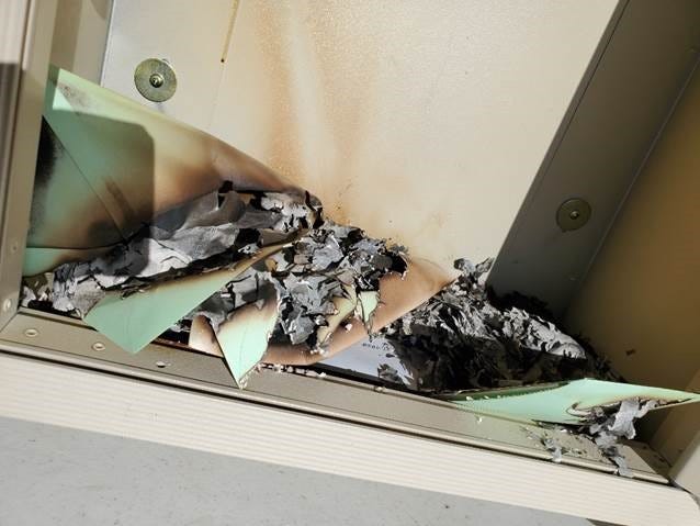 Fire damage to a drop box at the Income Support Division offices in Farmington is pictured on July 1.