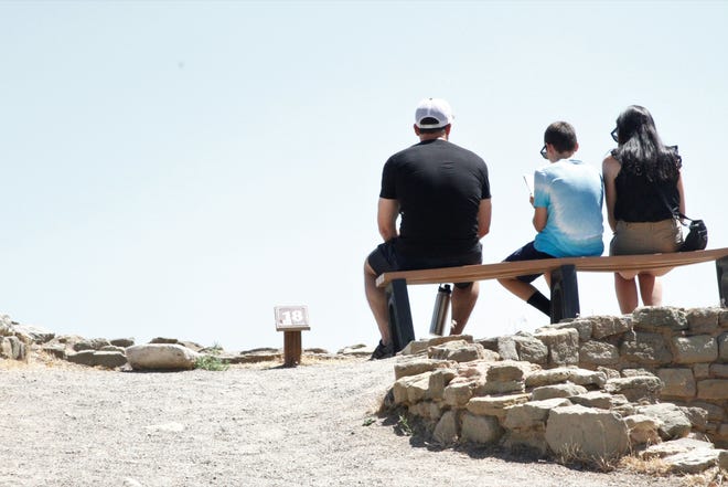 Tourists sit on a bench overlooking the Great Kiva, Thursday, July 2, 2020, at Aztec Ruins National Monument.