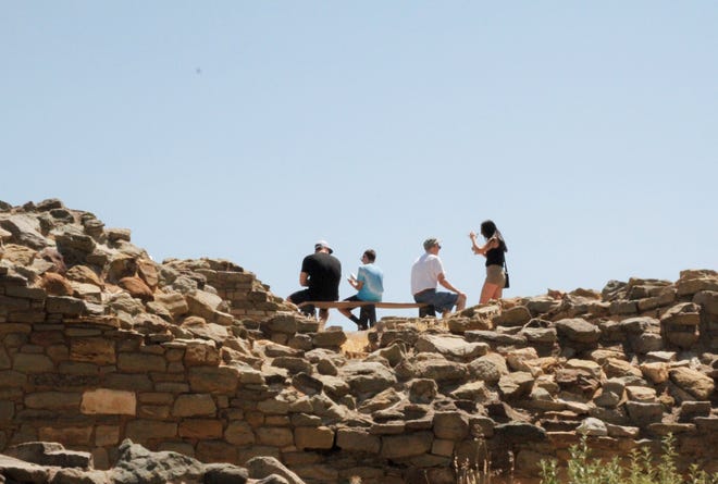 Tourists take a break on a bench, Thursday, July 2, 2020, at Aztec Ruins National Monument.