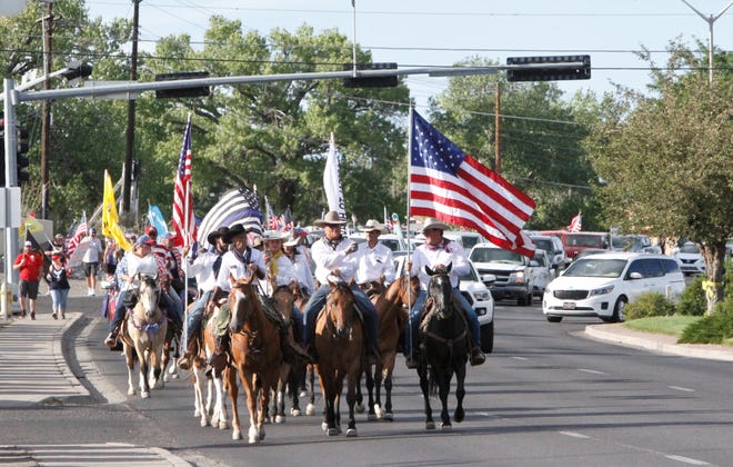 Participants in the Freedom March head toward the Farmington Museum on East Main Street, Saturday, July 11, 2020, after leaving the Animas Valley Mall in Farmington.