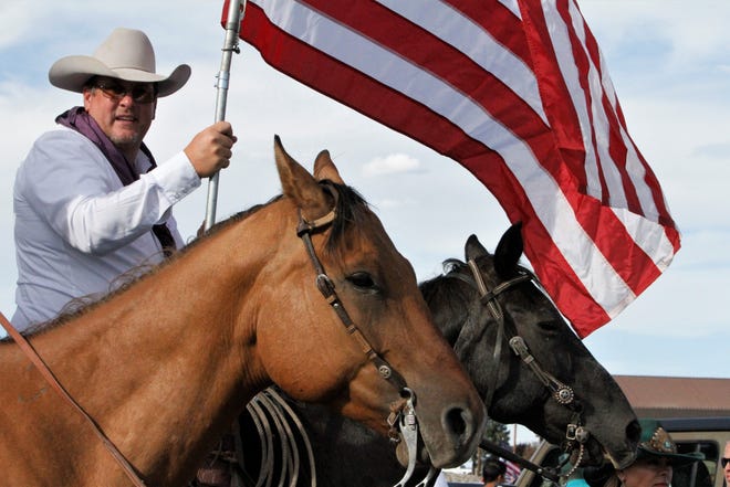 Members of Cowboys for Trump prepare to ride, Saturday, July 11, 2020, during the Freedom March in Farmington.