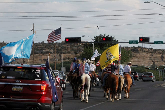 The Freedom March pauses at a traffic light, Saturday, July 11, 2020, at the intersection of East Main Street and 30th Street.