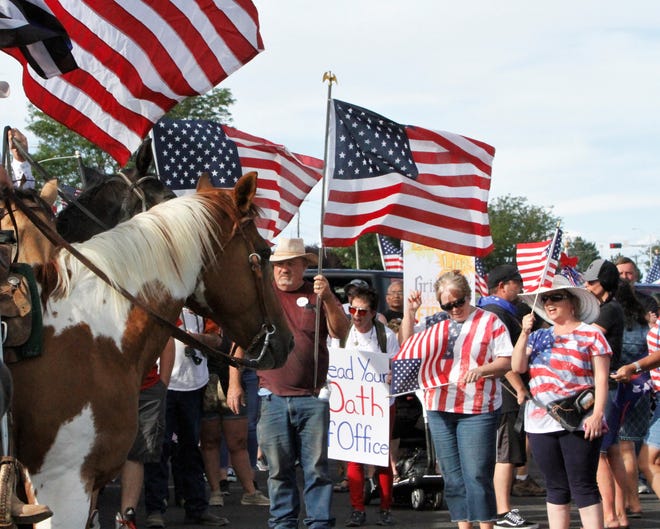 A crowd prepares to start the Freedom March, Saturday, July 11, 2020, in Farmington.