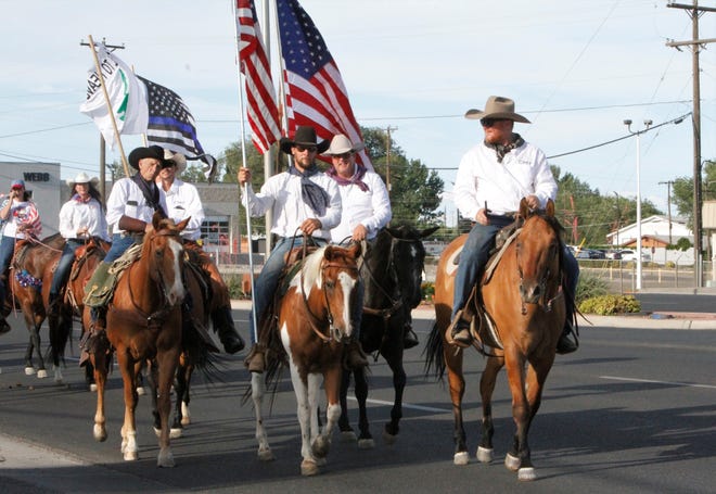 Members of Cowboys for Trump lead the Freedom March, Saturday, July 11, 2020, in Farmington.