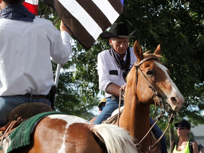 Ramie Harper rides, Friday, July 11, 2020, at the start of the Freedom March at Animas Valley Mall in Farmington.
