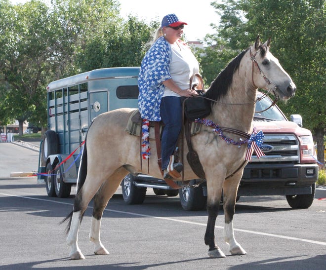 Jenny Albrecht prepares to ride her bucksin, Bailey, Saturday, July 11, 2020, during the Freedom March that began at the Animas Valley Mall.
