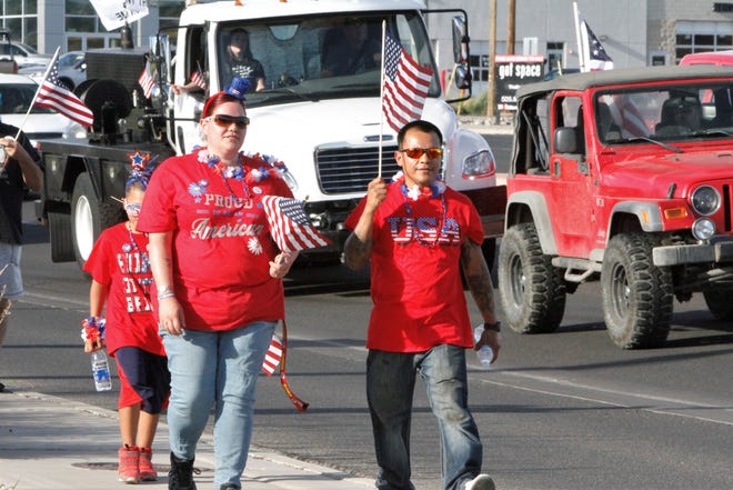 Vehicles and pedestrians participated in the Freedom March, Saturday, July 11, 2020, in Farmington.