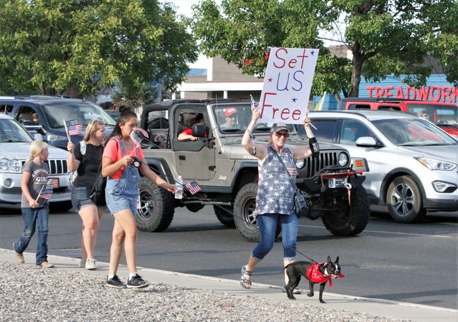 Participants in the Freedom March walk along East Main Street, Saturday, July 11, 2020, in Farmington.