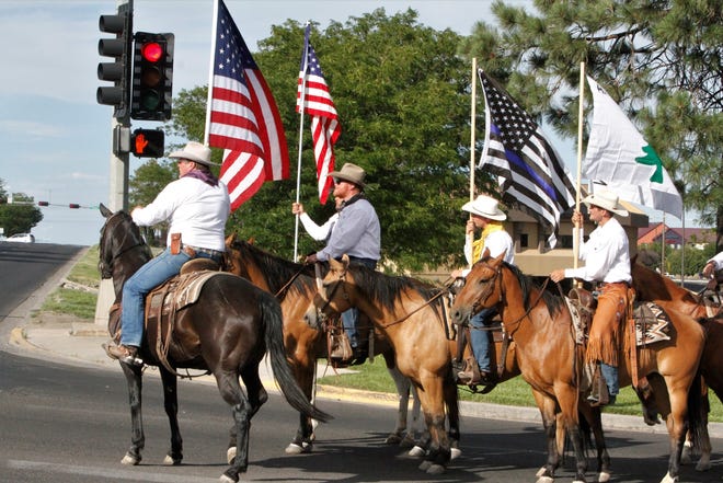 Cowboys for Trump pause at a traffic light, Saturday, July 11, 2020, while leaving Animas Valley Mall during the Freedom March in Farmington.