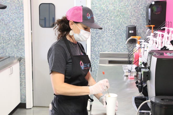 Ice Age Frozen Yogurt & Coffee co-owner Tessa Lucero prepares a latte on Monday, July 13, 2020. Ice Age, which opened on July 8, 2020, is located at 4005 E. Main St. in Farmington.