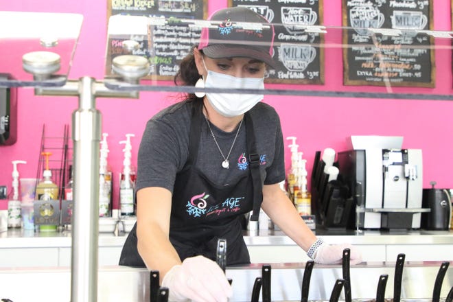 Ice Age Frozen Yogurt & Coffee co-owner Tessa Lucero, seen here on Monday, July 13, 2020, organizes frozen yogurt toppings. Ice Age, located at 4005 E. Main St. in Farmington., opened for business on July 8, 2020.
