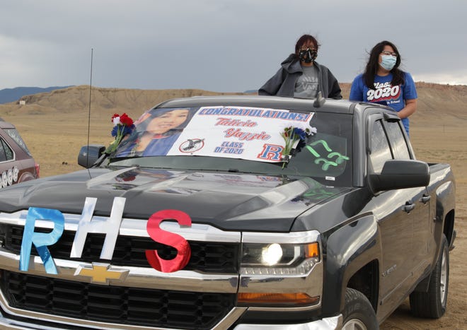 Tiona Wadsworth, left, and Talicia Yazzie wait for the parade on July 17 to celebrate graduates and the promotion of students from Sanostee. Wadsworth was promoted from eighth grade at Newcomb Middle School and Yazzie graduated from Richfield High School in Richfield, Utah.