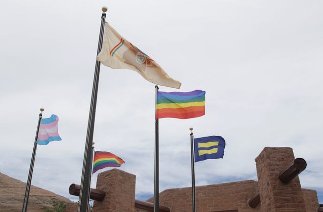 Clockwise from left, the transgender flag, Navajo Nation flag, gay pride flag, equality flag and inclusive flag fly on June 26 in front of the Navajo Nation Council chamber in Window Rock, Arizona.