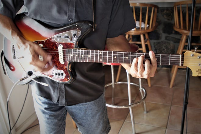 Gabriel Lucero strums the vintage Fender Jaguar electric guitar he inherited from his father, the subject of his song "Dust on It" from his new CD "Juice."
