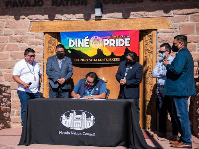 Speaker Seth Damon, center, signs on July 31 the Navajo Nation Council resolution to declare the third week in June of each year as Diné Pride Week on the Navajo Nation.