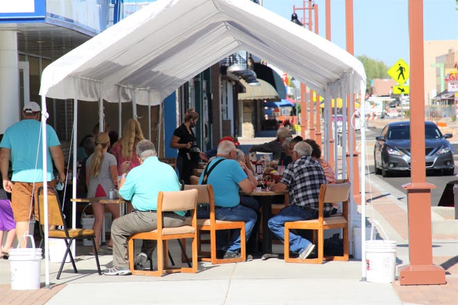 Customers are being served at outdoor seating at TJs Diner at 119 E. Main St., in Farmington, on Aug. 6.