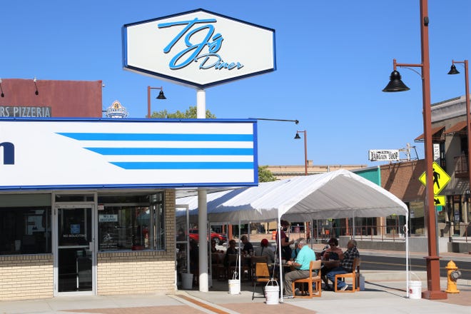 Customers in outdoor seating at TJs Diner at 119 E. Main St., in Farmington, on Aug. 6, are being served food. TJs and three restaurants are seeking to have the food service permits reinstated after violating the state's public health orders.