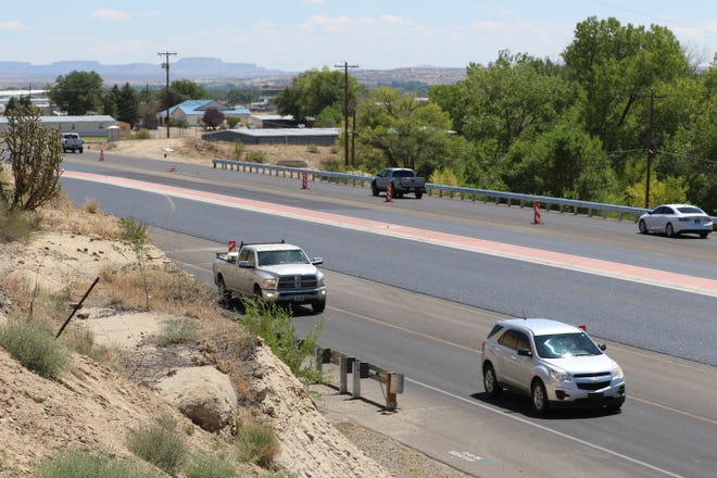 New asphalt glimmers in the inside two lanes of U.S. Highway 64 east of Andrea Drive on Aug. 12, 2020, as work on a widening project draws to a close.