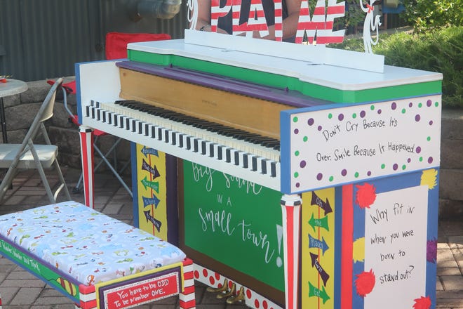 Artist Sandy Waybourn poses with her piano sporting a Dr. Seuss theme on Aug. 15, 2020, at the Main Avenue Plaza in Aztec.